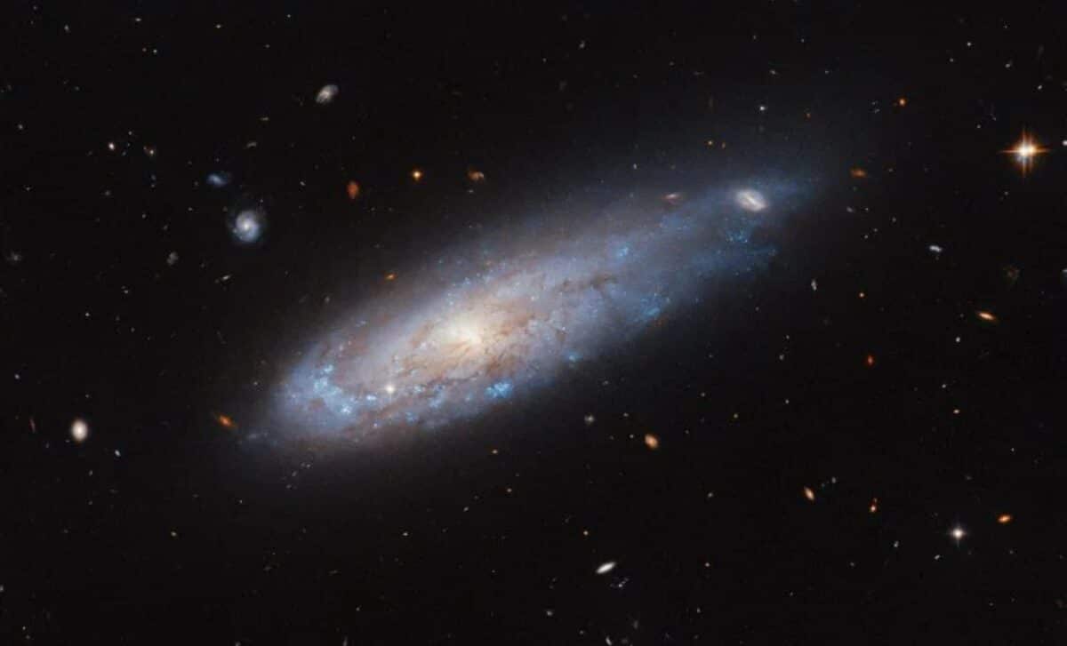 Hubble Captures Dramatic Image Of A Galaxy Racing Through Space, Shaped By Cosmic Forces